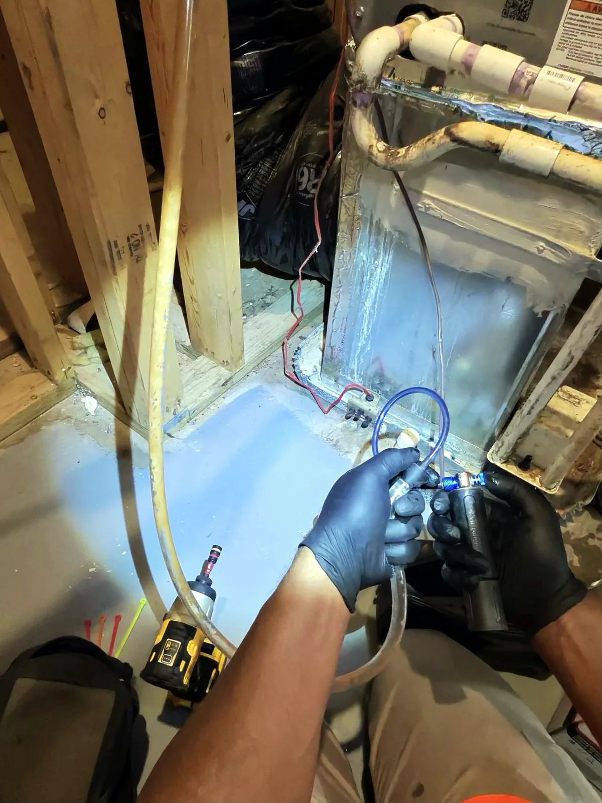 Cleaning out a condensate pump drain tubing with compressed air
